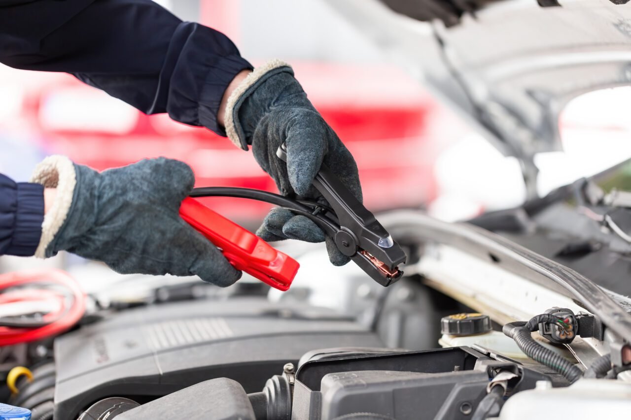 human-trying-to-start-engine-with-jumper-cables-in-close-up-e1697481896406.jpg